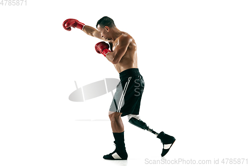 Image of Full length portrait of muscular sportsman with prosthetic leg, copy space. Male boxer in red gloves.