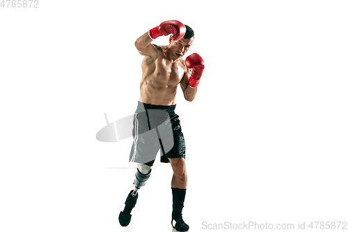 Image of Full length portrait of muscular sportsman with prosthetic leg, copy space. Male boxer in red gloves.