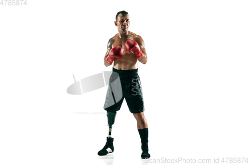 Image of Full length portrait of muscular sportsman with prosthetic leg, copy space. Male boxer in red gloves.