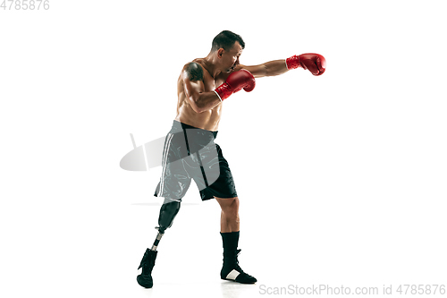 Image of Full length portrait of muscular sportsman with prosthetic leg, copy space. Male boxer in red gloves.