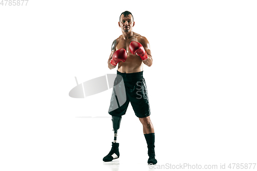 Image of Full length portrait of muscular sportsman with prosthetic leg, copy space. Male boxer in red gloves.