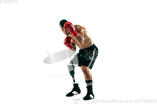 Image of Full length portrait of muscular sportsman with prosthetic leg, copy space. Male boxer in red gloves.