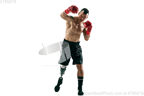 Image of Full length portrait of muscular sportsman with prosthetic leg, copy space. Male boxer in red gloves.