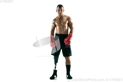 Image of Full length portrait of muscular sportsman with prosthetic leg, copy space. Male boxer in red gloves.