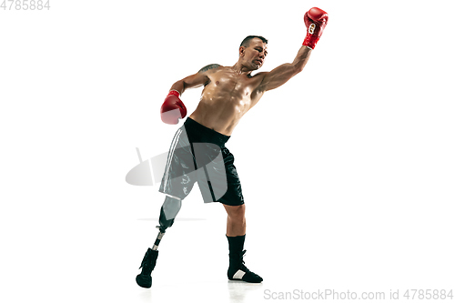 Image of Full length portrait of muscular sportsman with prosthetic leg, copy space. Male boxer in red gloves.