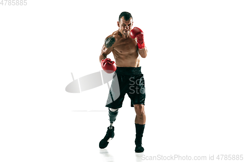 Image of Full length portrait of muscular sportsman with prosthetic leg, copy space. Male boxer in red gloves.