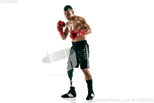 Image of Full length portrait of muscular sportsman with prosthetic leg, copy space. Male boxer in red gloves.