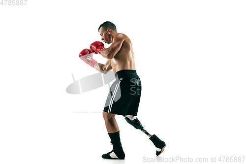 Image of Full length portrait of muscular sportsman with prosthetic leg, copy space. Male boxer in red gloves.