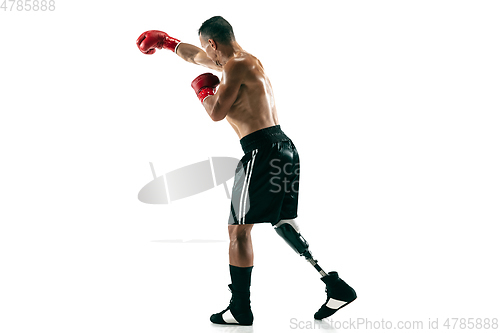 Image of Full length portrait of muscular sportsman with prosthetic leg, copy space. Male boxer in red gloves.