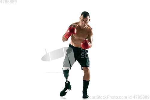 Image of Full length portrait of muscular sportsman with prosthetic leg, copy space. Male boxer in red gloves.