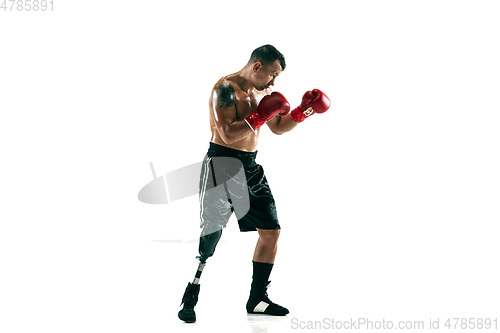 Image of Full length portrait of muscular sportsman with prosthetic leg, copy space. Male boxer in red gloves.