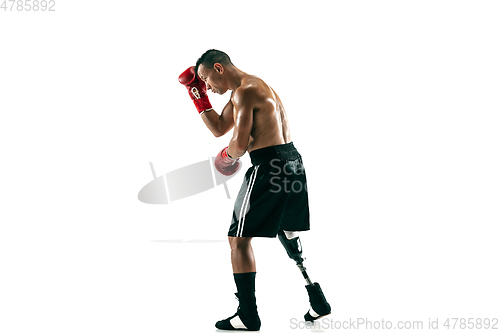 Image of Full length portrait of muscular sportsman with prosthetic leg, copy space. Male boxer in red gloves.