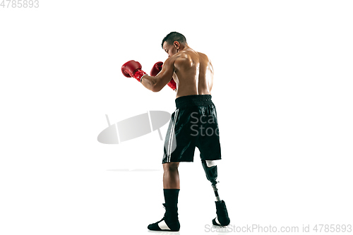 Image of Full length portrait of muscular sportsman with prosthetic leg, copy space. Male boxer in red gloves.