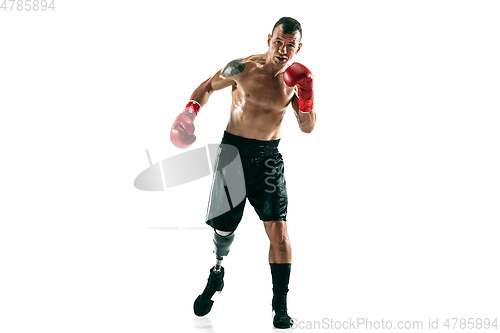 Image of Full length portrait of muscular sportsman with prosthetic leg, copy space. Male boxer in red gloves.