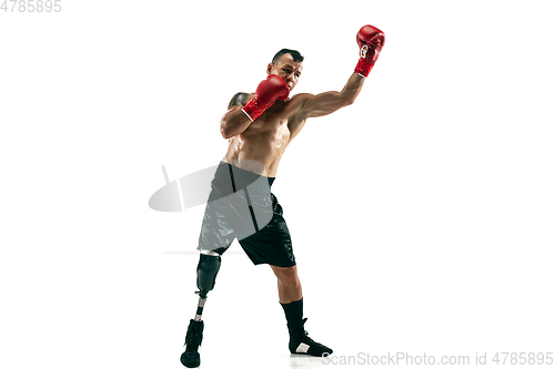 Image of Full length portrait of muscular sportsman with prosthetic leg, copy space. Male boxer in red gloves.