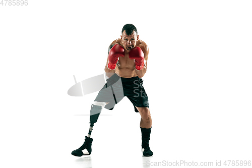 Image of Full length portrait of muscular sportsman with prosthetic leg, copy space. Male boxer in red gloves.