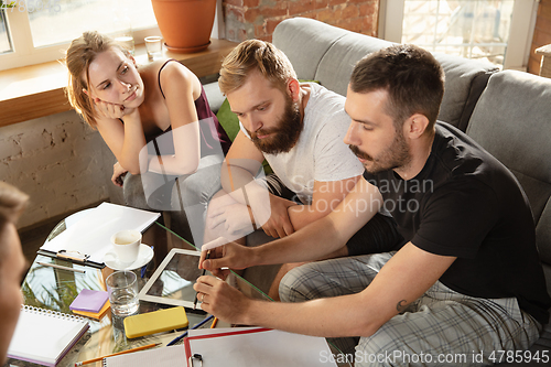 Image of Group of young caucasian office workers have creative meeting to discuss new ideas