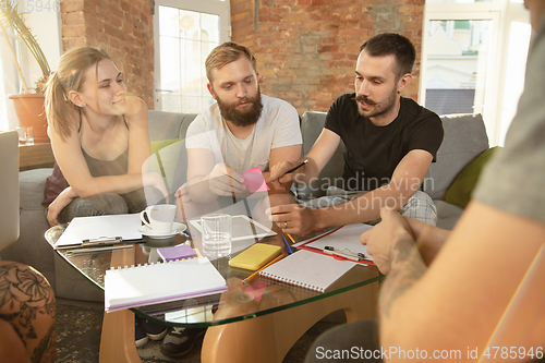 Image of Group of young caucasian office workers have creative meeting to discuss new ideas