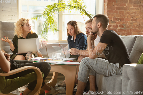 Image of Group of young caucasian office workers have creative meeting to discuss new ideas