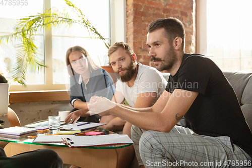 Image of Group of young caucasian office workers have creative meeting to discuss new ideas