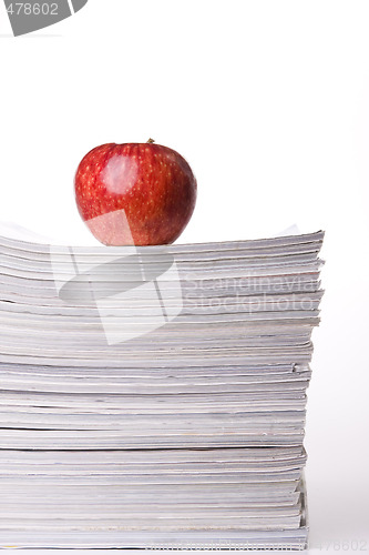 Image of Apple in a stack of books