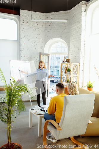 Image of Interior designer working with young couple. Lovely family and professional designer or architector.