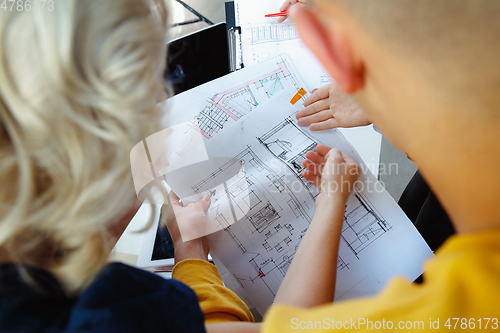 Image of Interior designer working with young couple. Lovely family and professional designer or architector.