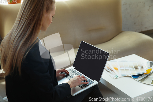 Image of Interior designer working in modern office. Young business woman in contemporary interior.