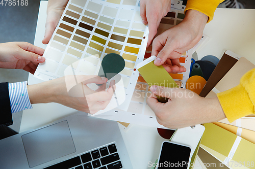 Image of Interior designer working with young couple. Lovely family and professional designer or architector.