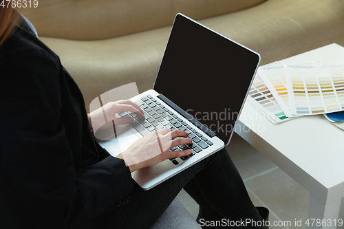 Image of Interior designer working in modern office. Young business woman in contemporary interior.