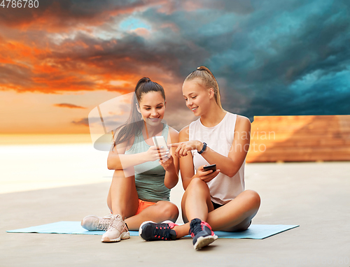 Image of sporty women or friends with smartphone