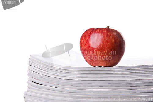 Image of Apple over a stack of books