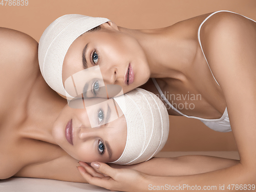 Image of Portrait of beautiful young women isolated on brown studio background