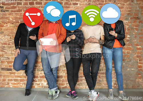 Image of Creative millenial people connecting and sharing social media. Modern UI icons as heads