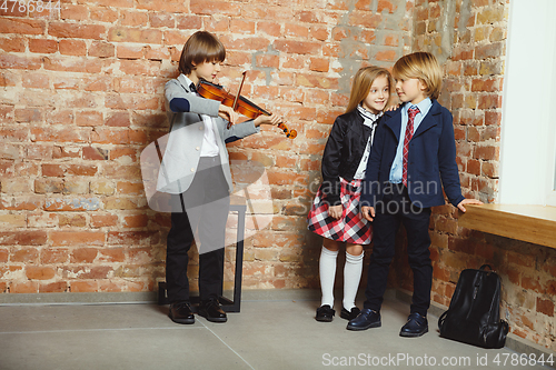 Image of Group of kids spending time after school together. Handsome frie