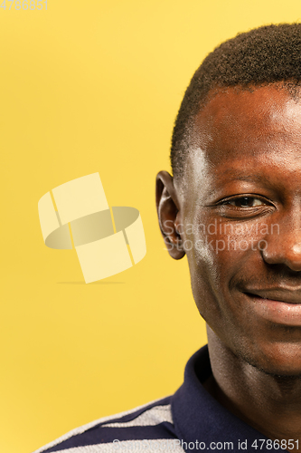 Image of African-american young man\'s close up portrait on yellow background