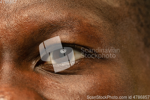 Image of African-american young man\'s close up portrait on yellow background