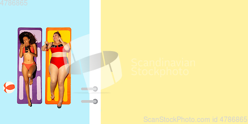 Image of Top view of young caucasian model\'s resting on beach resort
