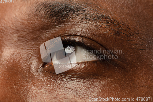 Image of African-american young man\'s close up portrait on blue background