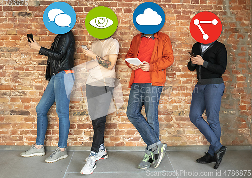 Image of Creative millenial people connecting and sharing social media. Modern UI icons as heads