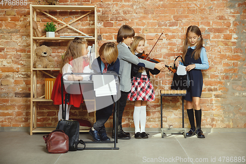 Image of Group of kids spending time after school together. Handsome frie