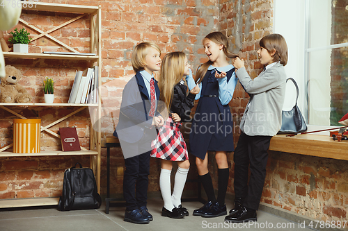Image of Group of kids spending time after school together. Handsome frie