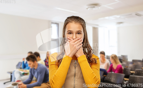 Image of scared student girl closing mouth at school