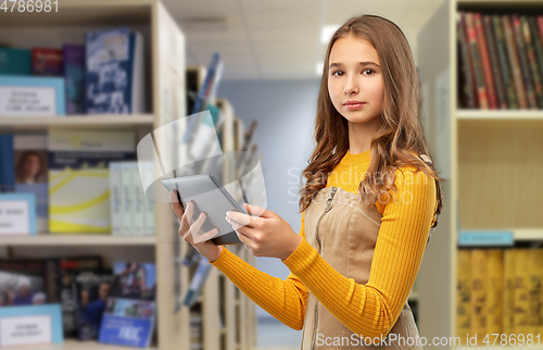 Image of student girl using tablet computer at library