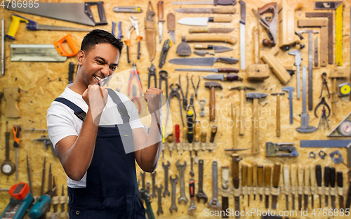 Image of happy indian worker or builder celebrating success