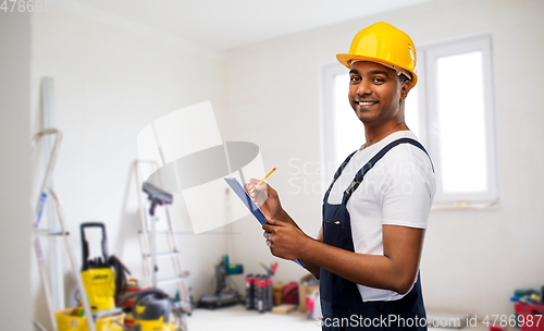 Image of happy builder in helmet with clipboard and pencil