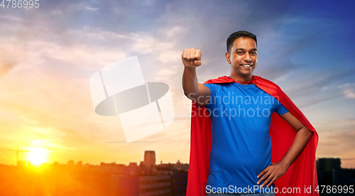 Image of indian man in superhero cape makes winning gesture