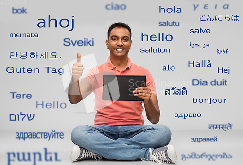 Image of happy indian man with tablet pc showing thumbs up