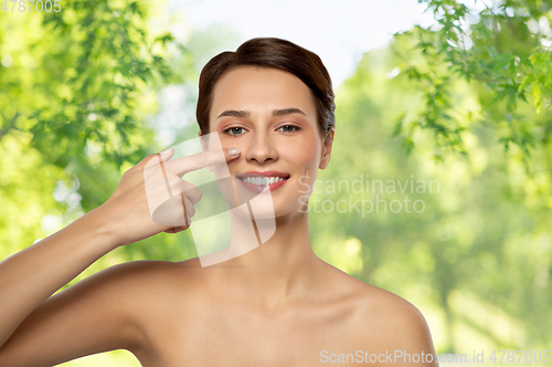 Image of beautiful smiling woman showing her nose