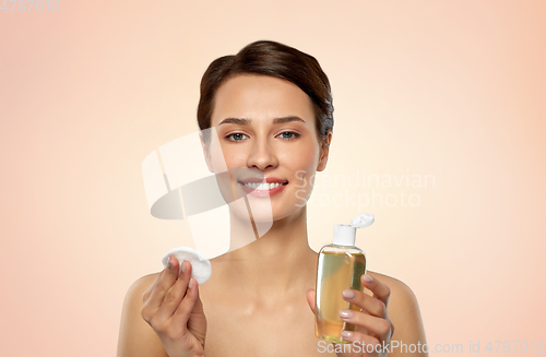 Image of young woman with toner or cleanser and cotton pad